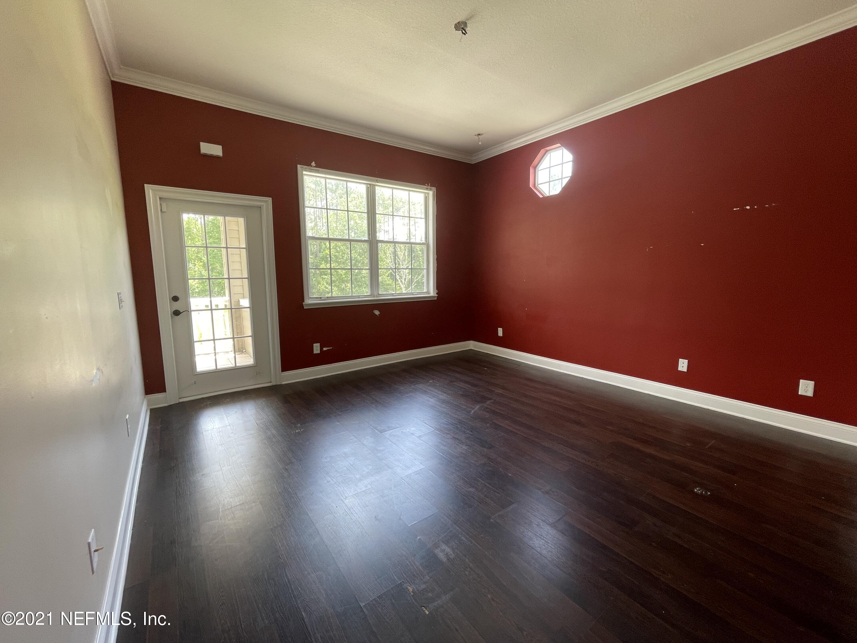 127 Foxcraft Street St. Augustine, FL 32092 - Photo 70 of 77 an empty room with wooden floor and windows