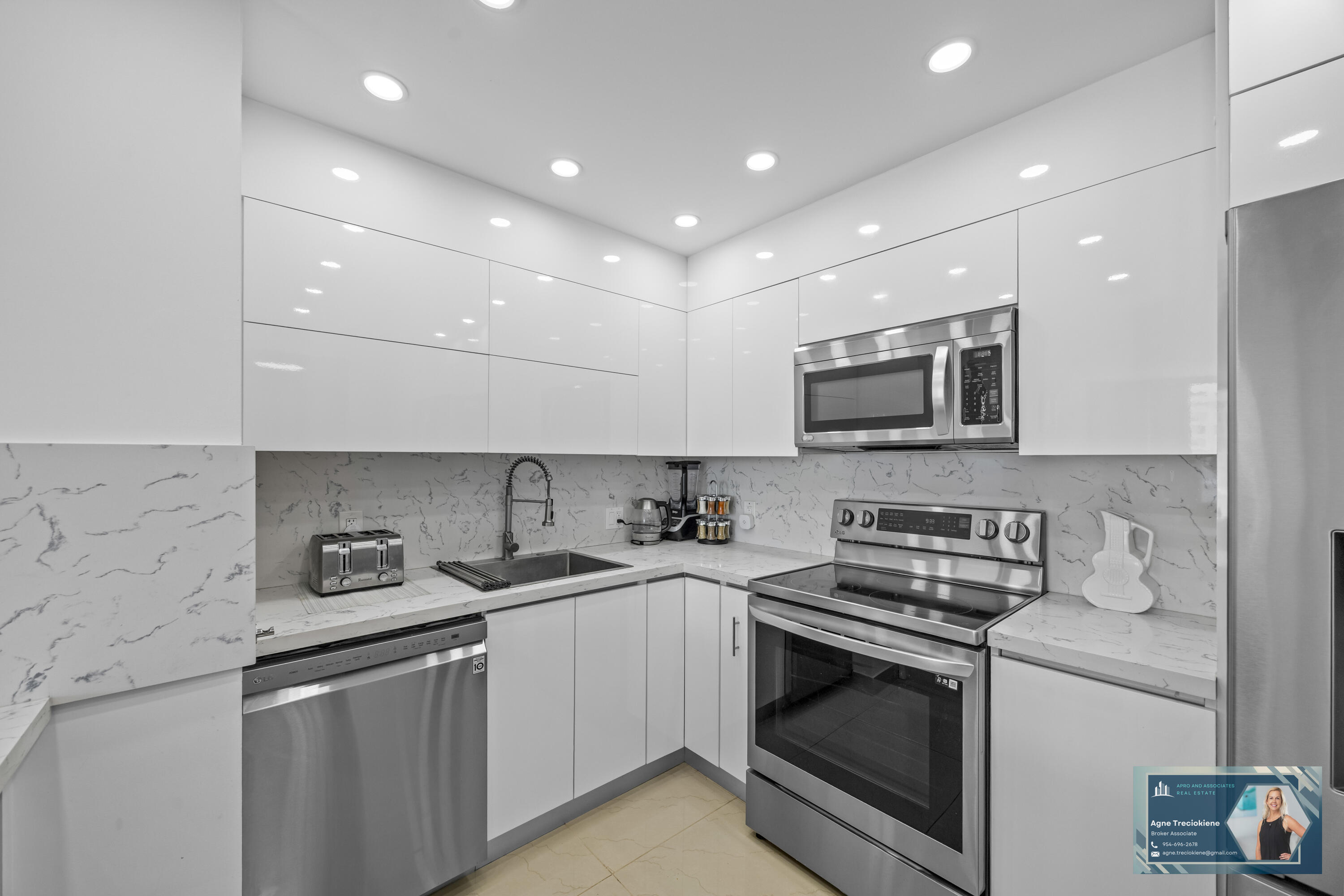 2801 Northeast 183rd Street, Unit 1606W Aventura, FL 33160 - Photo 11 of 53 a kitchen with stainless steel appliances granite countertop a sink stove a microwave and cabinets