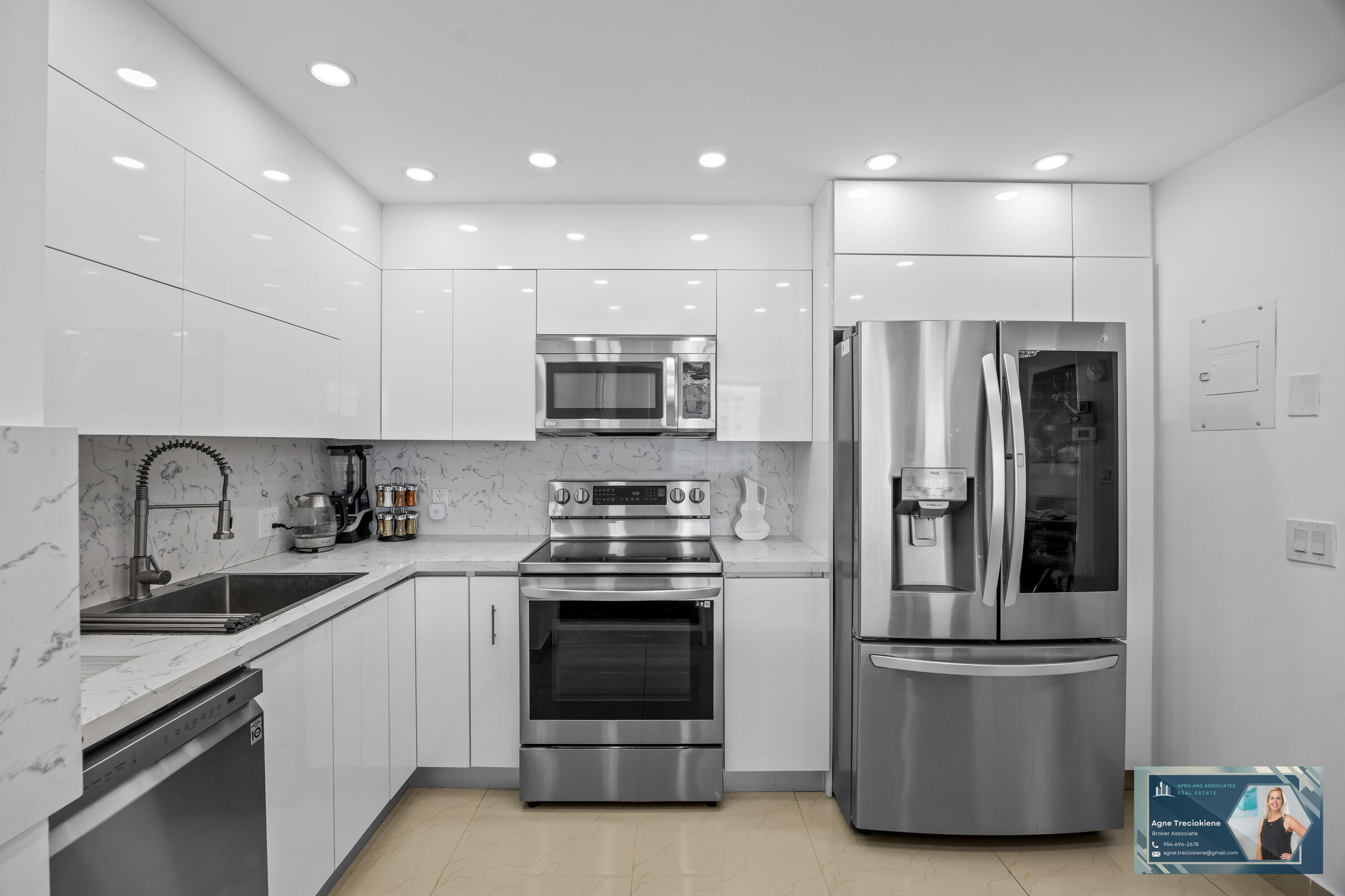 2801 Northeast 183rd Street, Unit 1606W Aventura, FL 33160 - Photo 12 of 53 a kitchen with stainless steel appliances a refrigerator sink and microwave