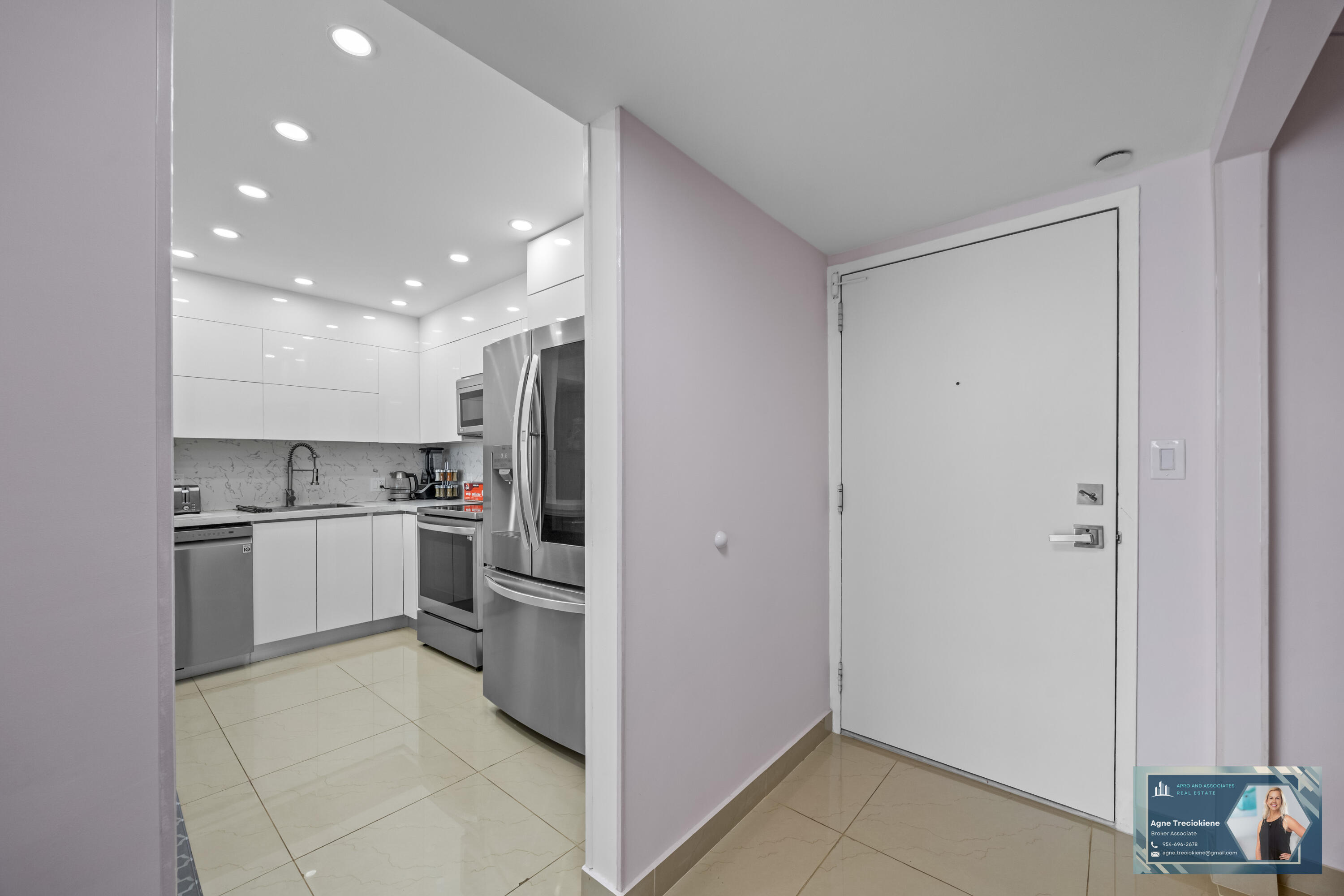 2801 Northeast 183rd Street, Unit 1606W Aventura, FL 33160 - Photo 18 of 53 a kitchen with a refrigerator and white cabinets