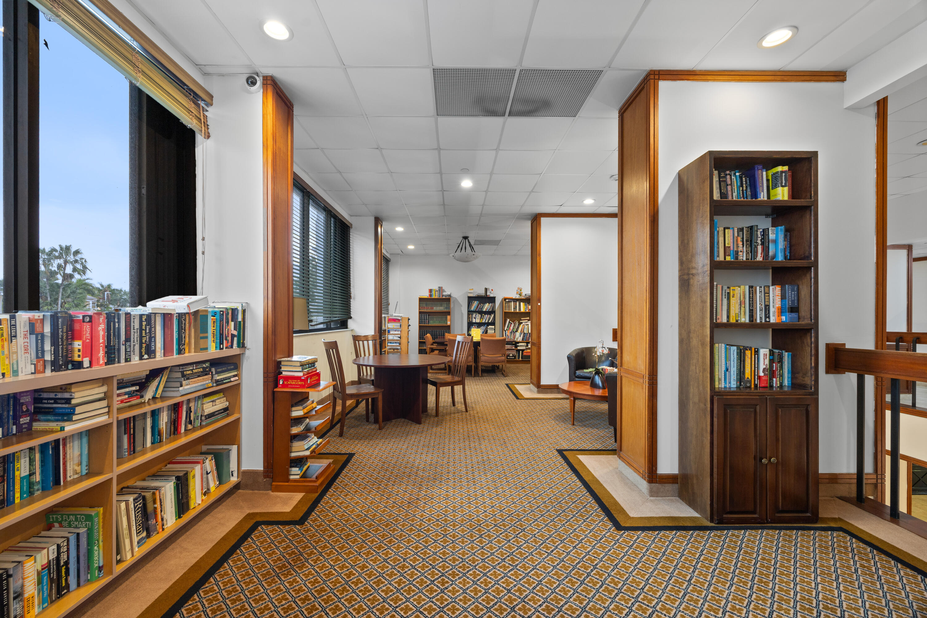 2801 Northeast 183rd Street, Unit 1606W Aventura, FL 33160 - Photo 41 of 53 a living room with furniture and a book shelf