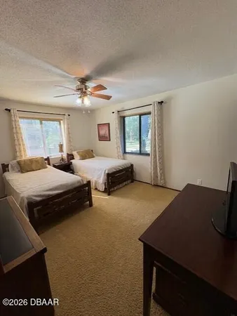a bedroom with a bed and a desk