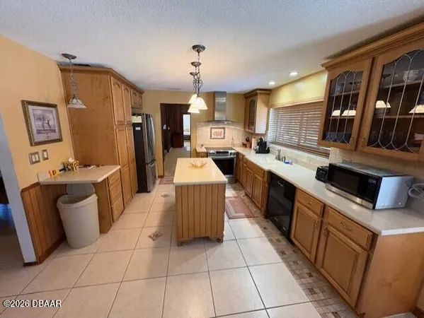 a large kitchen with a large counter top appliances and cabinets