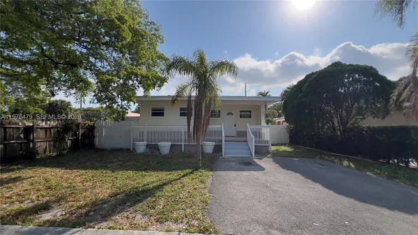 a view of a house with a yard and pathway