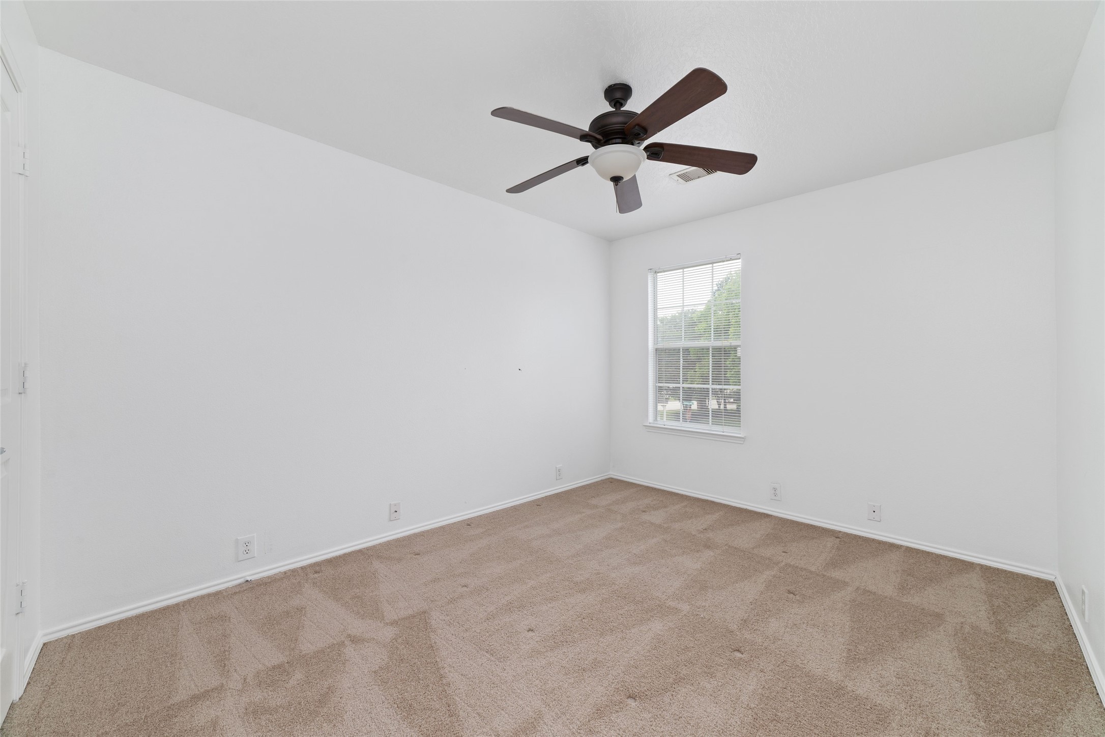 23602 Youpon Lake Lane Spring, TX 77373 - Photo 16 of 21 Cozy secondary bedroom with natural light and ceiling fan.