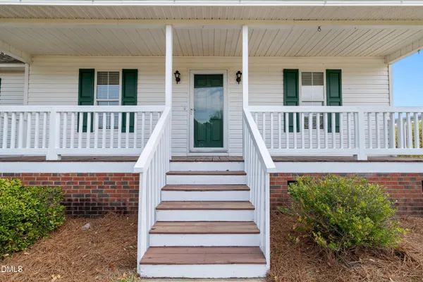 a view of a house with wooden fence