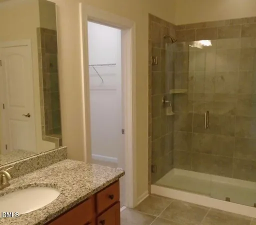 a bathroom with a granite countertop sink and shower