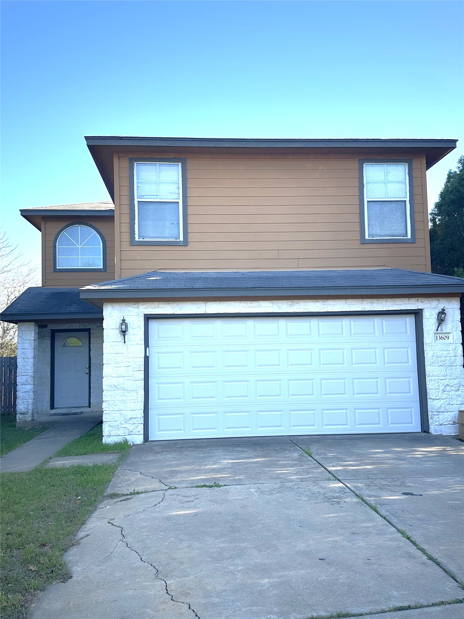 a front view of a house with a yard and garage
