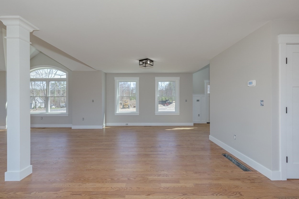4 Haystack Circle Pelham, NH 03076 - Photo 18 of 39 an empty room with wooden floor and windows
