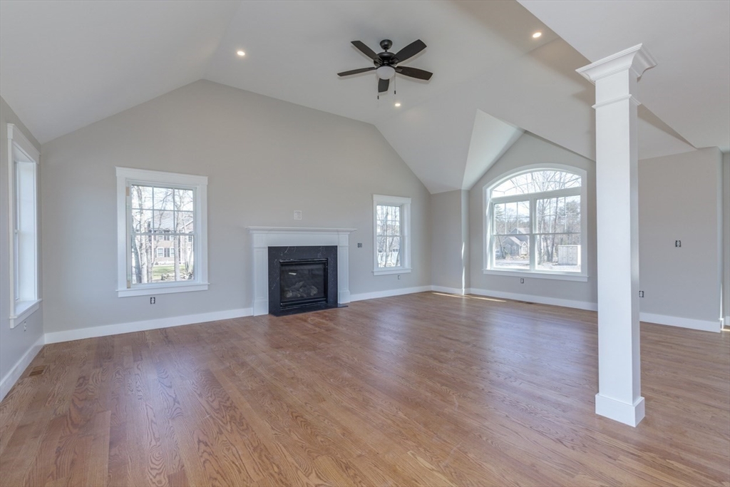 4 Haystack Circle Pelham, NH 03076 - Photo 22 of 39 a view of an empty room with wooden floor and a window