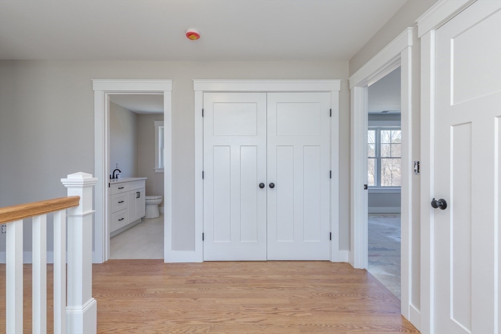 4 Haystack Circle Pelham, NH 03076 - Photo 26 of 39 a view of a hallway with closet and wooden floor