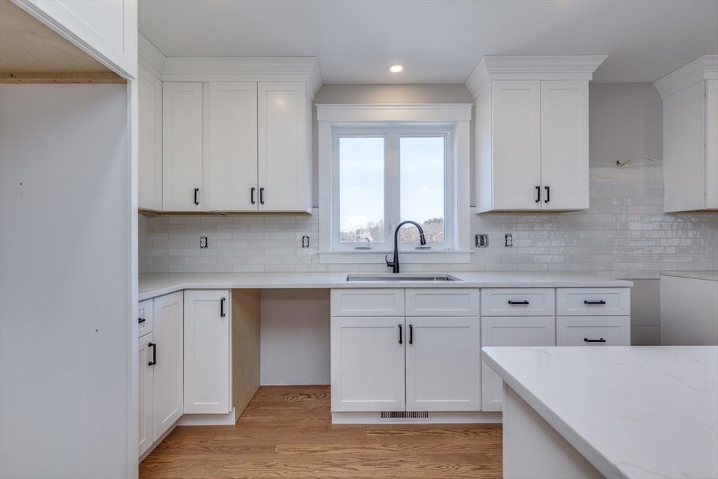 4 Haystack Circle Pelham, NH 03076 - Photo 3 of 39 a kitchen with appliances cabinets and a sink