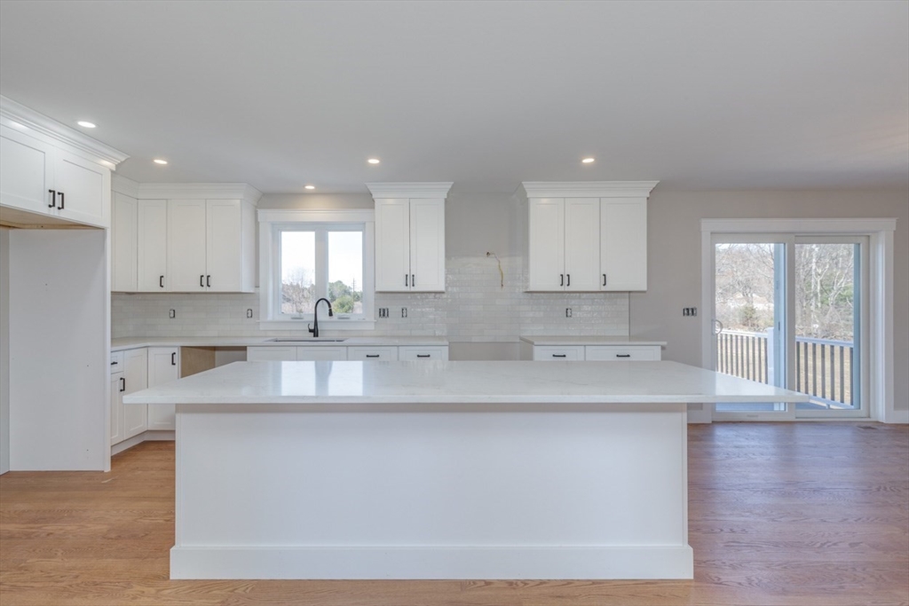 4 Haystack Circle Pelham, NH 03076 - Photo 4 of 39 a large kitchen with kitchen island a sink appliances and cabinets