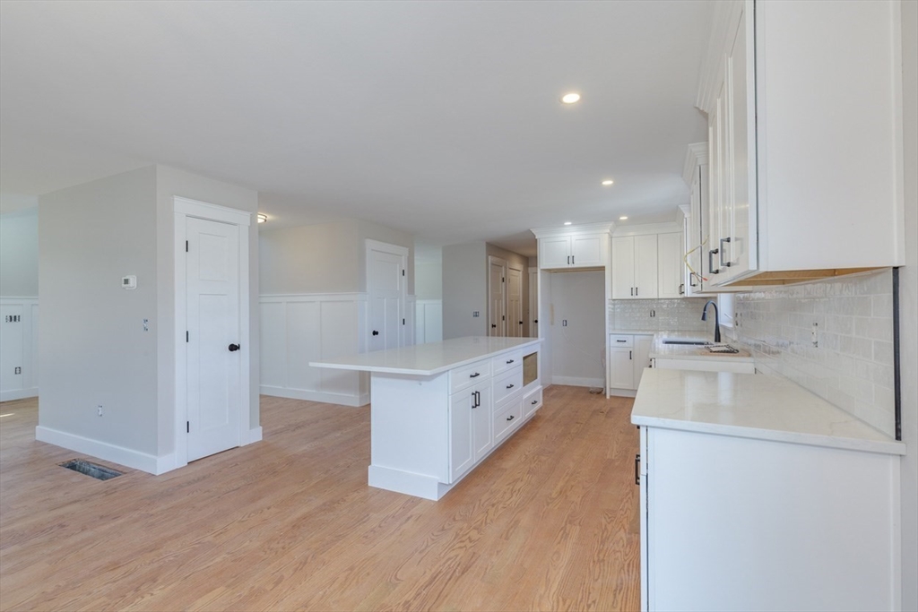 4 Haystack Circle Pelham, NH 03076 - Photo 7 of 39 a large kitchen with stainless steel appliances granite countertop a sink and cabinets