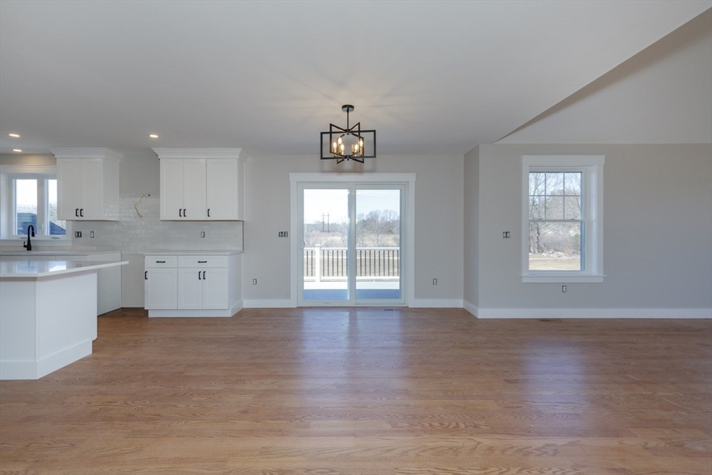 4 Haystack Circle Pelham, NH 03076 - Photo 8 of 39 a view of a kitchen with wooden floor and a window