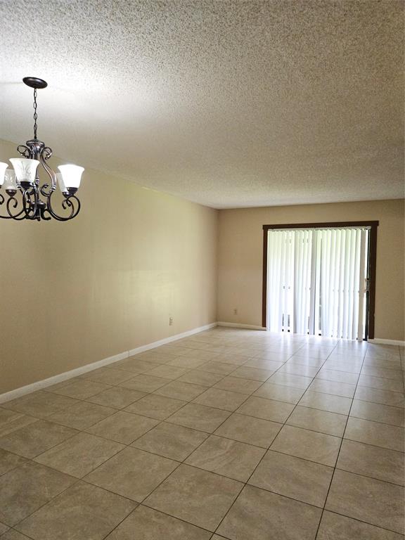 10601 Northwest 11th Street, Unit 10601 Hollywood, FL 33026 - Photo 6 of 9 an empty room with a chandelier