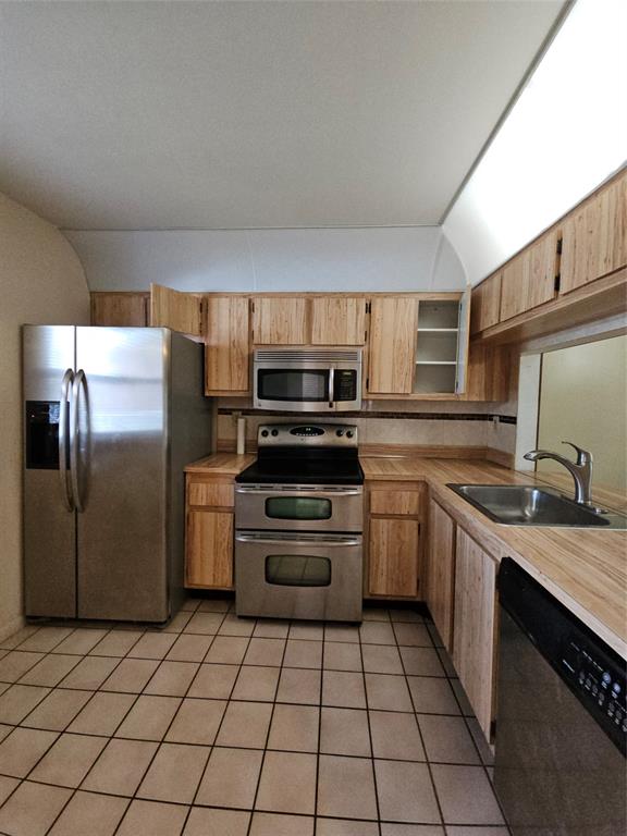 10601 Northwest 11th Street, Unit 10601 Hollywood, FL 33026 - Photo 9 of 9 a kitchen with a stove sink and refrigerator