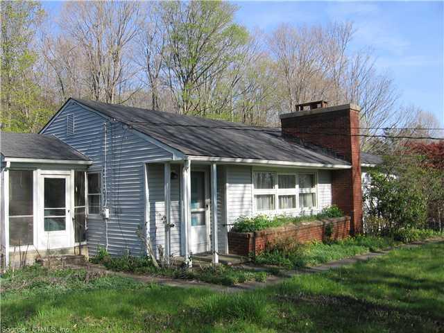 a view of a house with a yard and plants