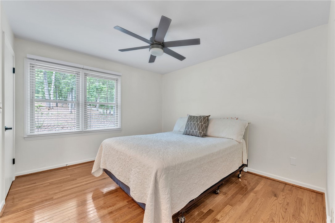 4416 Denver Cove Road Anderson, SC 29625 - Photo 18 of 31 Wood flooring and a modern ceiling fan complement the sun-filled ambiance of this tranquil room.