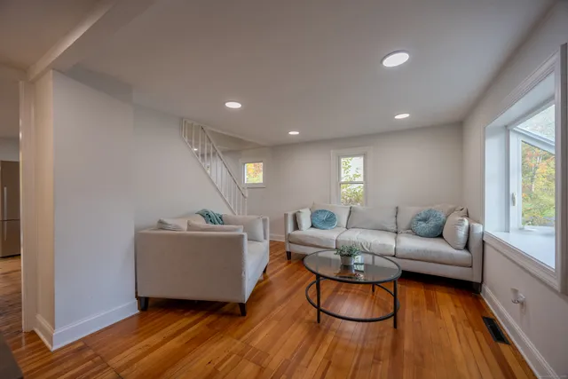 a living room with furniture and a wooden floor