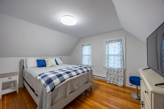 a bedroom with a bed and a flat screen tv