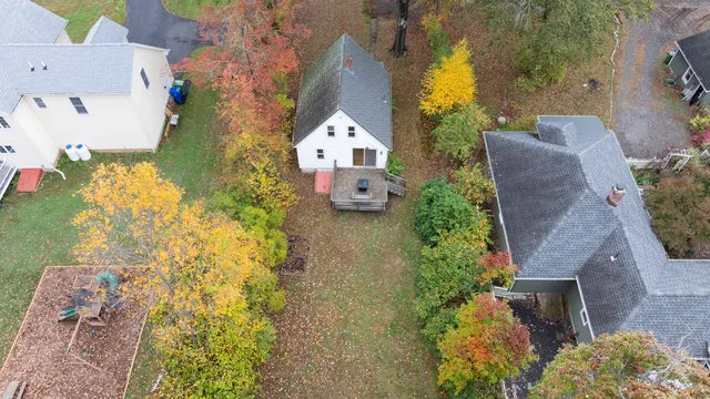 an aerial view of a house with a yard basket ball court and outdoor seating