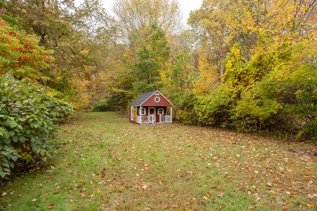 a view of a large tree in front of a house