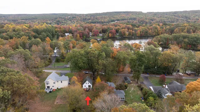 an aerial view of a house with a lake view