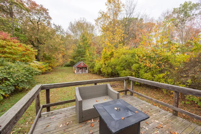 a view of a balcony with wooden floor and fence