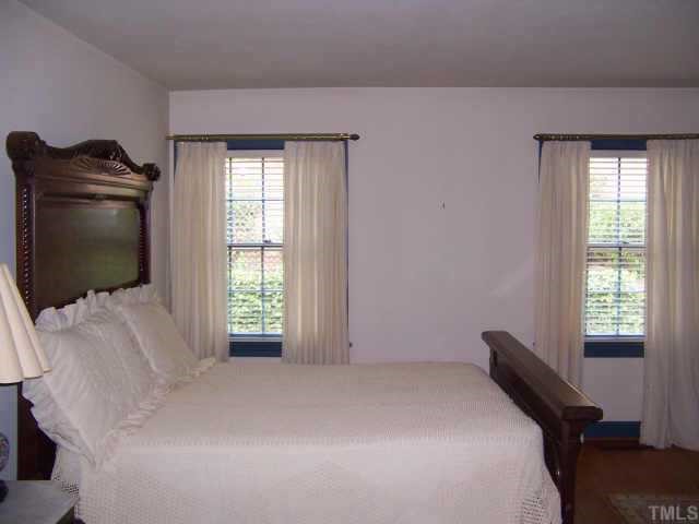 2609 Churchill Road Raleigh, NC 27608 - Photo 8 of 10 a bedroom with a bed and flat screen tv