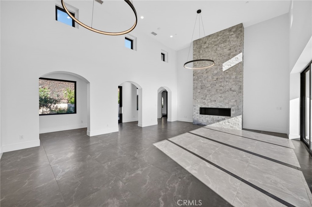 43754 De Luz Road Temecula, CA 92590 - Photo 27 of 74 a bedroom with a bed and a chandelier