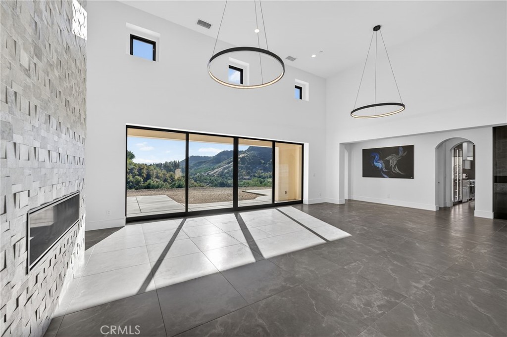 43754 De Luz Road Temecula, CA 92590 - Photo 28 of 74 a view of an empty room with a fireplace and a window