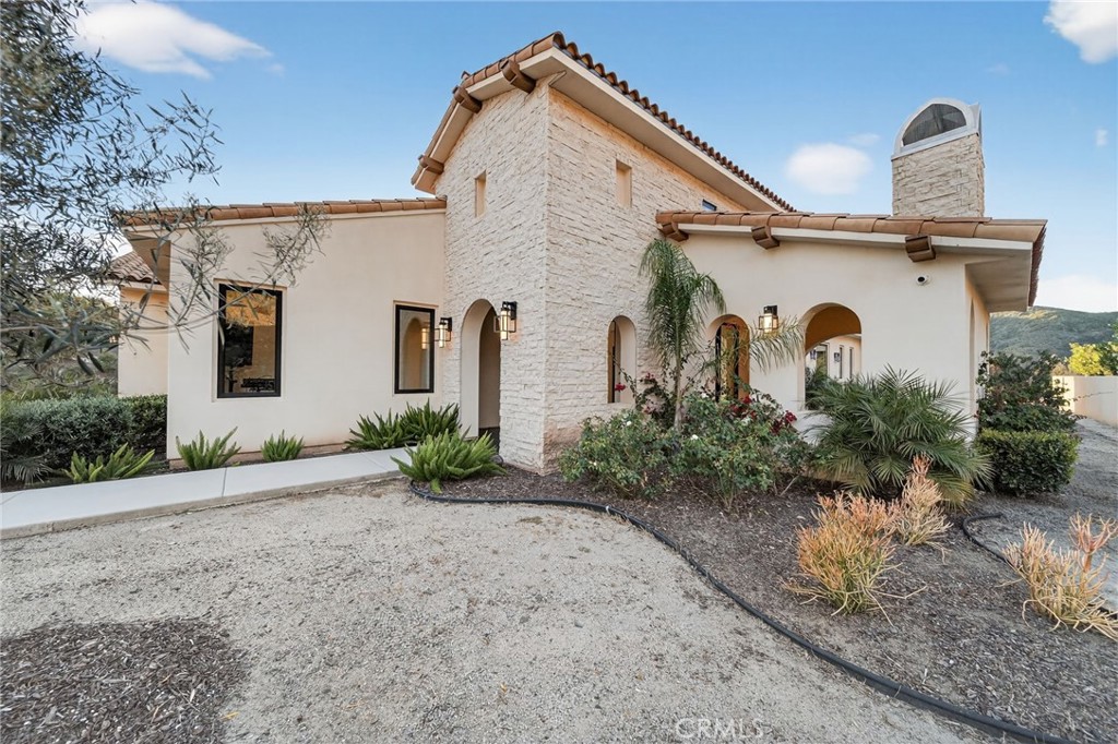 43754 De Luz Road Temecula, CA 92590 - Photo 3 of 75 a front view of a house with garden