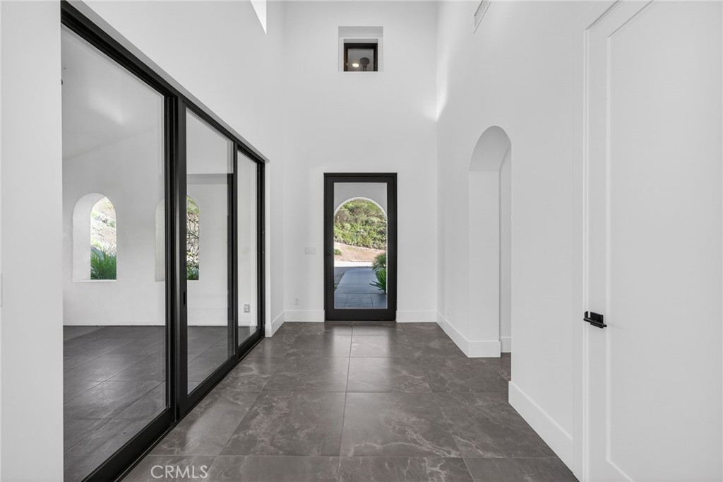 43754 De Luz Road Temecula, CA 92590 - Photo 31 of 74 a view of a hallway with wooden floor and windows