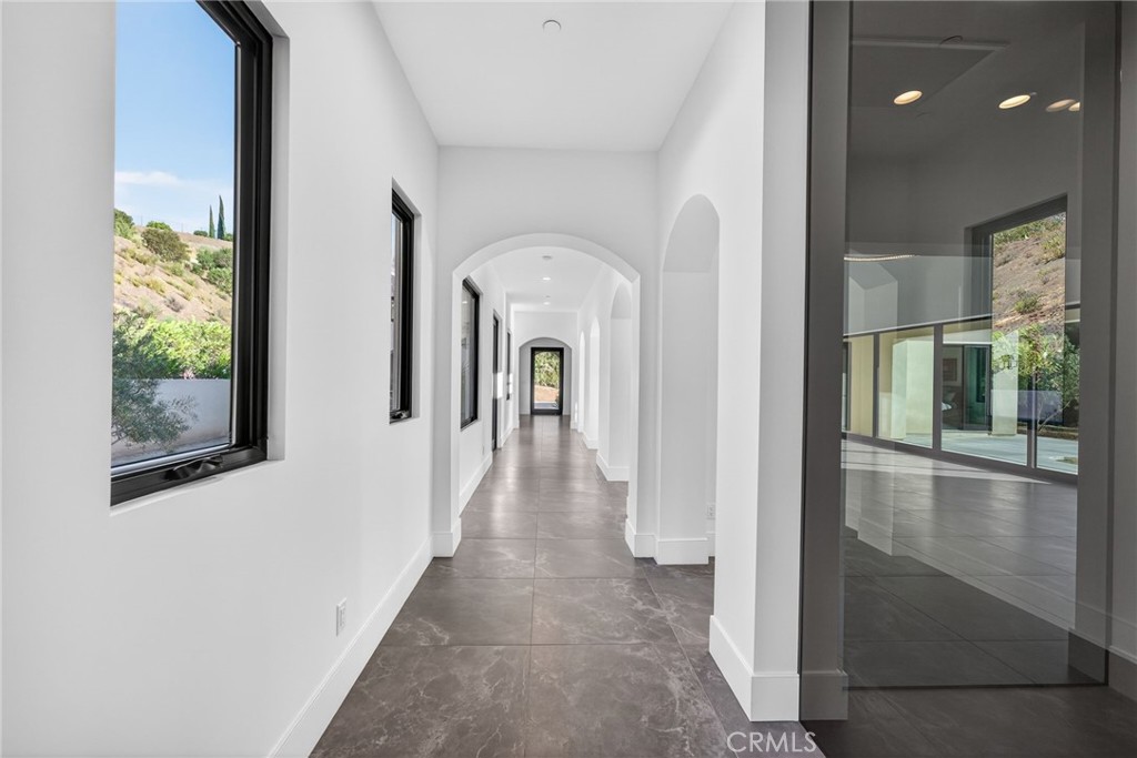 43754 De Luz Road Temecula, CA 92590 - Photo 32 of 74 a view of a hallway with windows and stairs