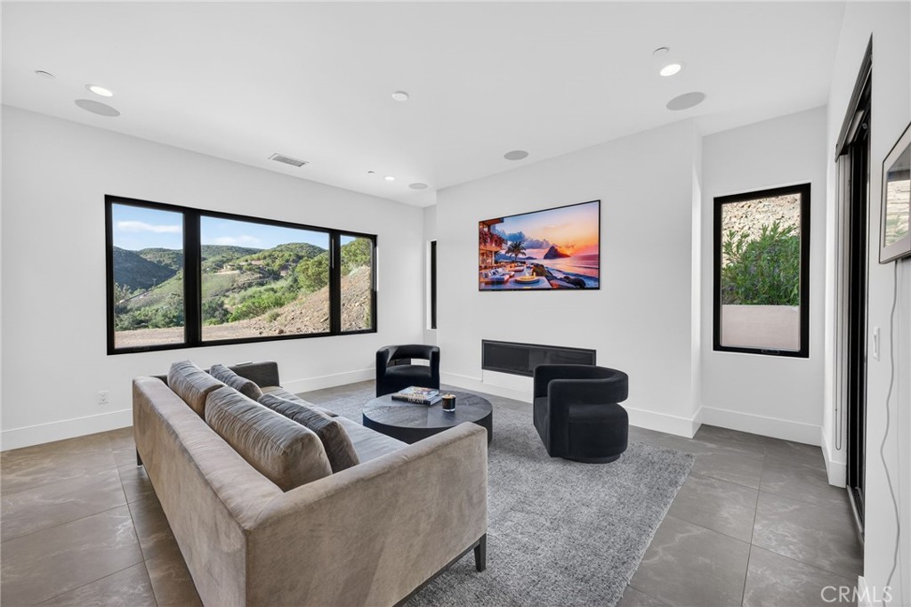 43754 De Luz Road Temecula, CA 92590 - Photo 35 of 74 a living room with furniture and a flat screen tv