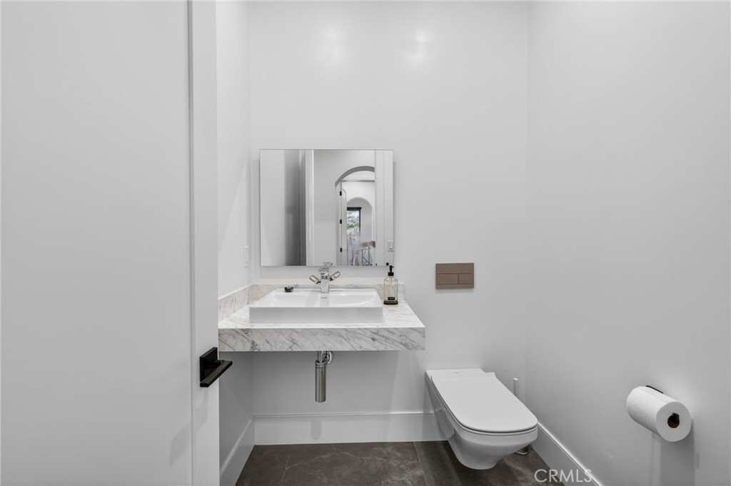 43754 De Luz Road Temecula, CA 92590 - Photo 54 of 74 a bathroom with a toilet a sink and mirror