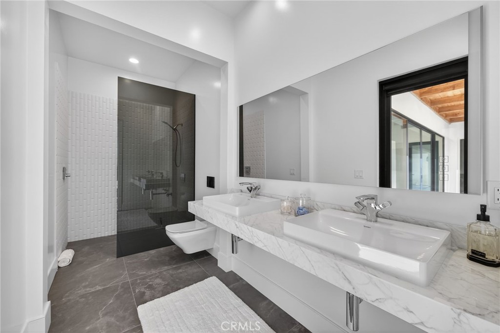 43754 De Luz Road Temecula, CA 92590 - Photo 58 of 74 a spacious bathroom with a double vanity sink toilet and shower