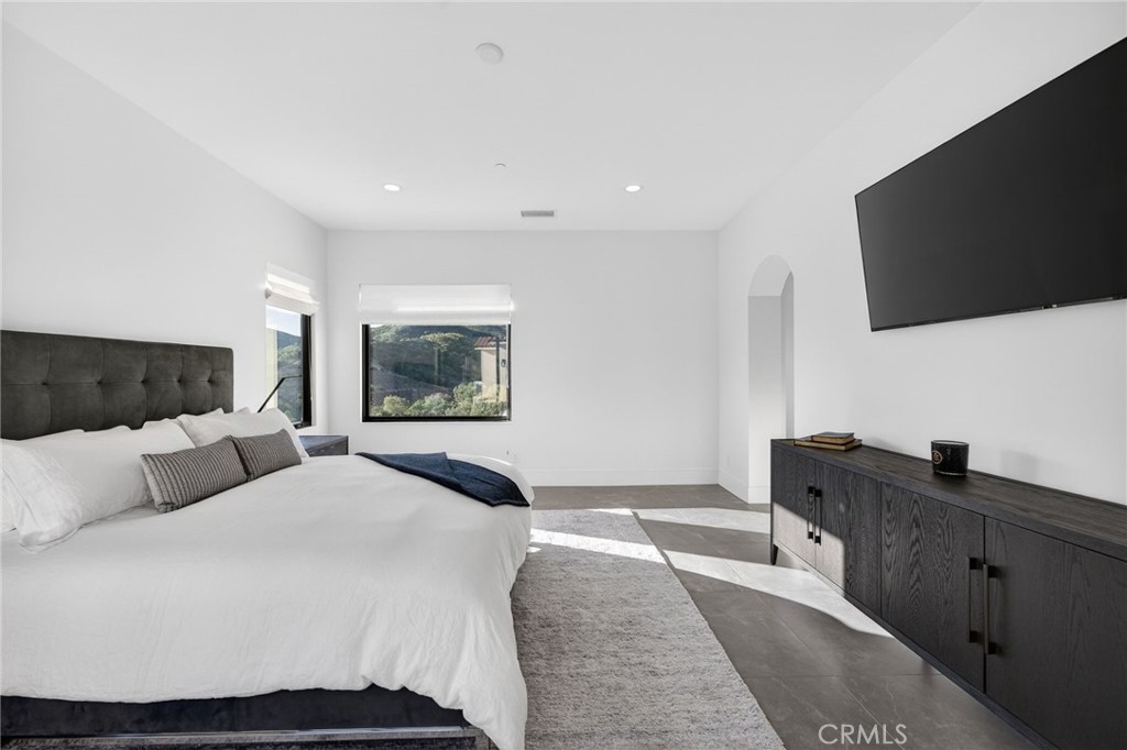 43754 De Luz Road Temecula, CA 92590 - Photo 62 of 74 a bedroom with a large bed and a flat screen tv