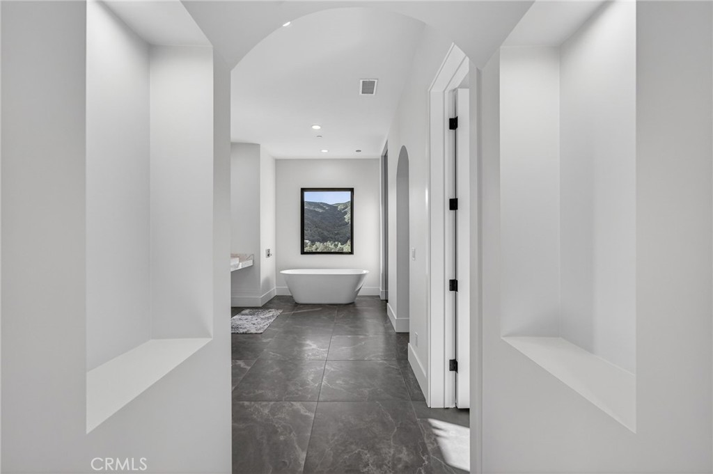 43754 De Luz Road Temecula, CA 92590 - Photo 68 of 74 a bathroom with a bathtub and a toilet