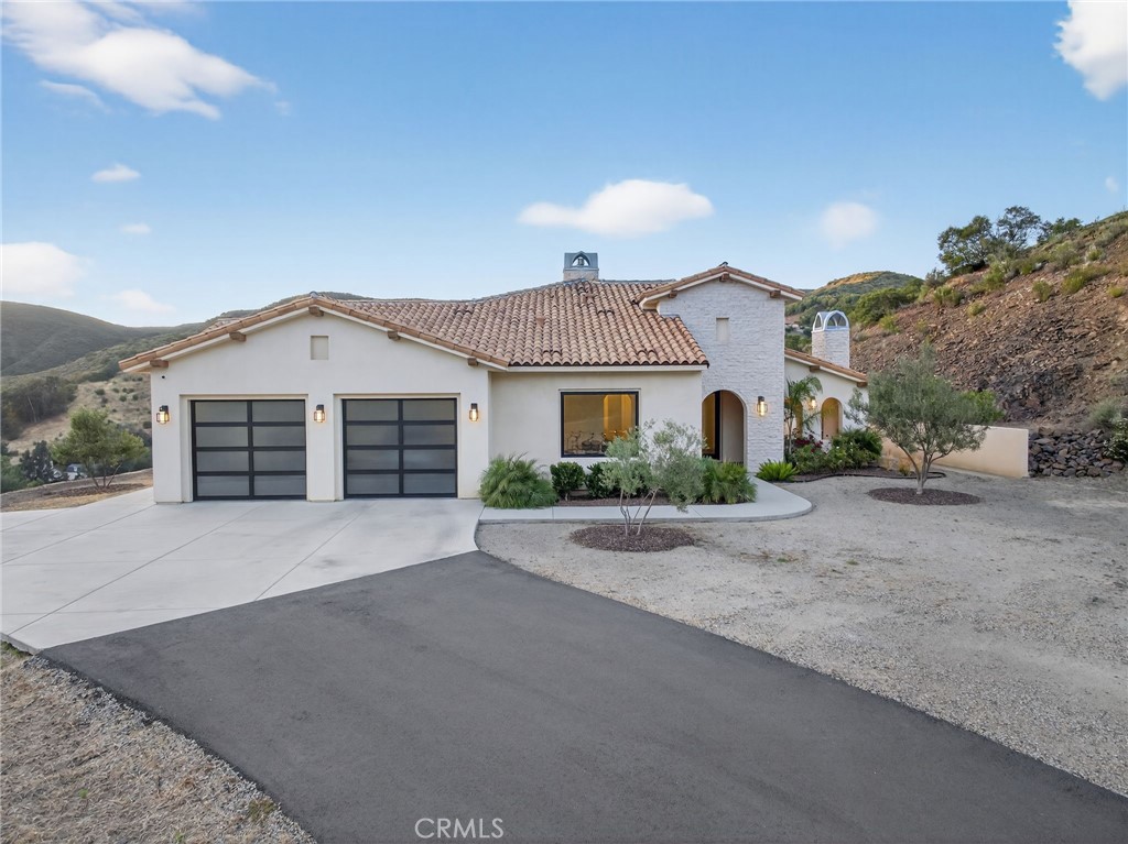 43754 De Luz Road Temecula, CA 92590 - Photo 8 of 75 a front view of a house with a yard and garage