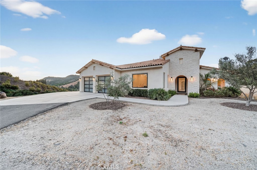 43754 De Luz Road Temecula, CA 92590 - Photo 9 of 75 a front view of a house with a yard and garage