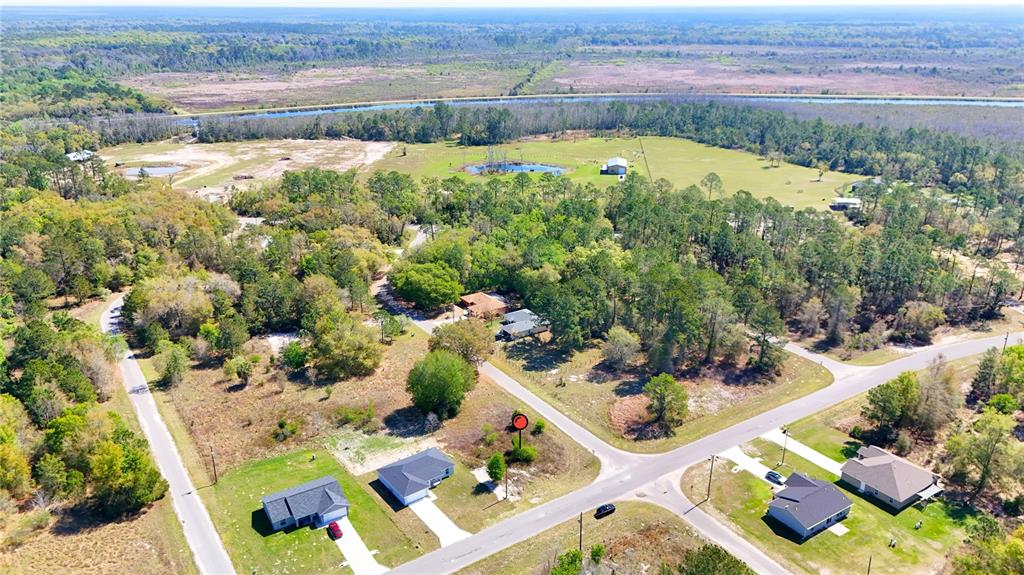 Tbd Tbd Corner Road Ocklawaha, FL 32179 - Photo 9 of 12 an aerial view of a house with a garden and lake view