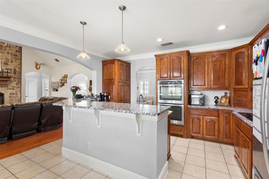 2000 Pin Oak Drive Kaufman, TX 75142 - Photo 12 of 40 a kitchen with stainless steel appliances granite countertop a refrigerator a sink dishwasher a stove and white cabinets with wooden floor