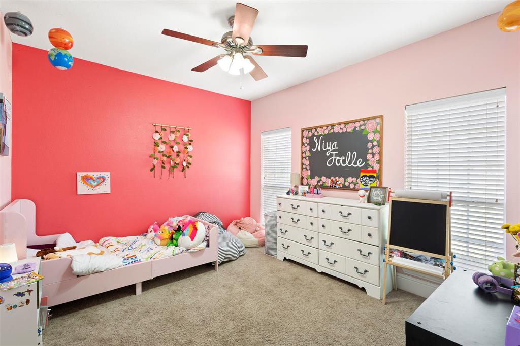 2000 Pin Oak Drive Kaufman, TX 75142 - Photo 18 of 40 a bedroom with a bed and a desk