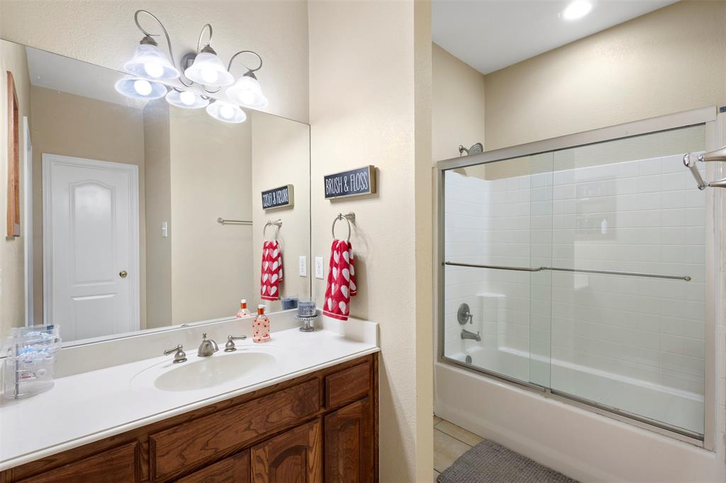 2000 Pin Oak Drive Kaufman, TX 75142 - Photo 22 of 40 a bathroom with a sink vanity and a mirror