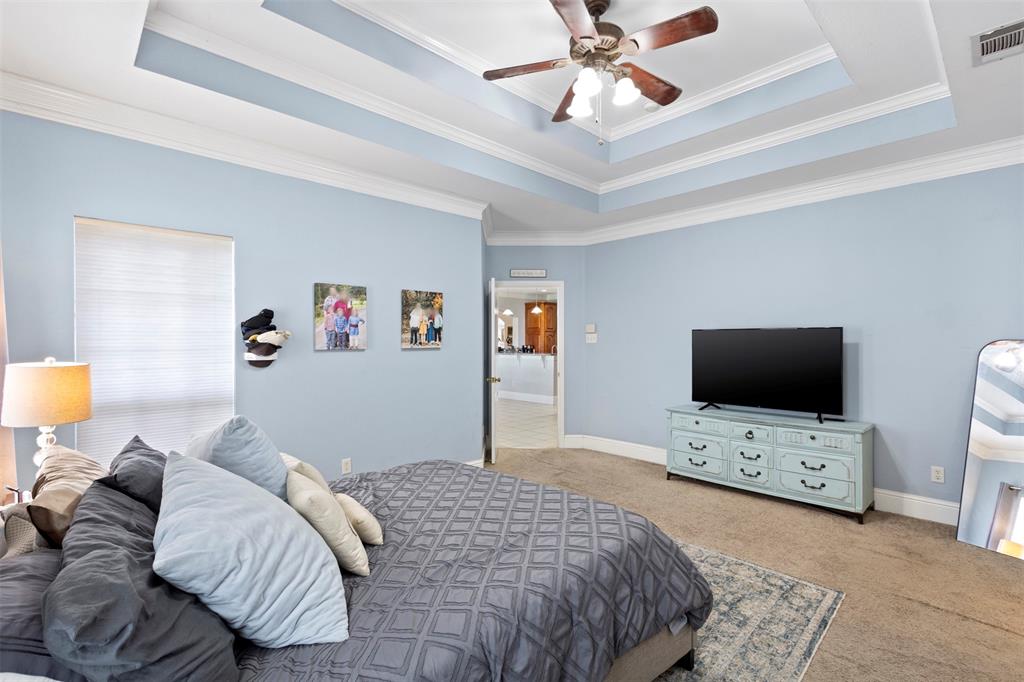 2000 Pin Oak Drive Kaufman, TX 75142 - Photo 26 of 40 a bedroom with a bed and a flat screen tv