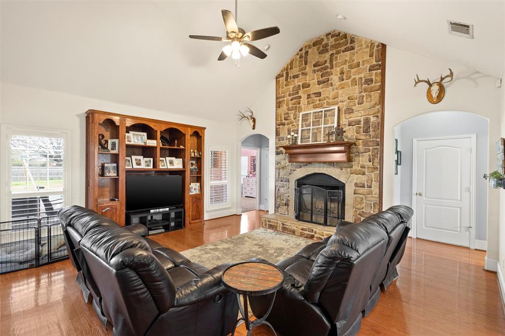 2000 Pin Oak Drive Kaufman, TX 75142 - Photo 8 of 40 a living room with furniture a fireplace and a flat screen tv