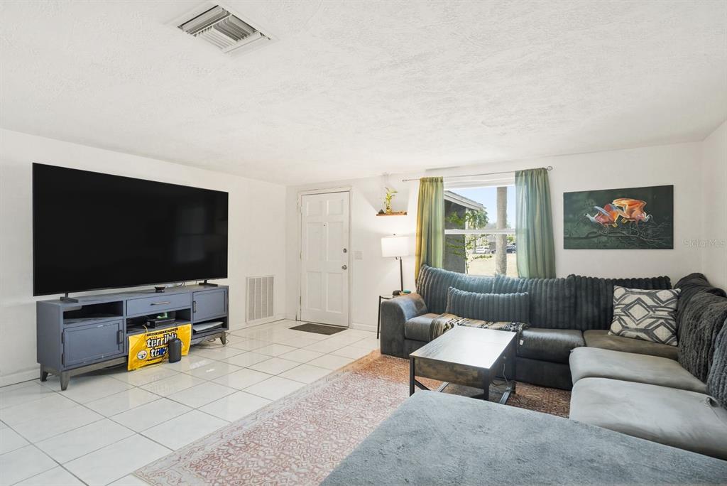 4276 Rudder Way New Port Richey, FL 34652 - Photo 2 of 29 a living room with furniture and a flat screen tv