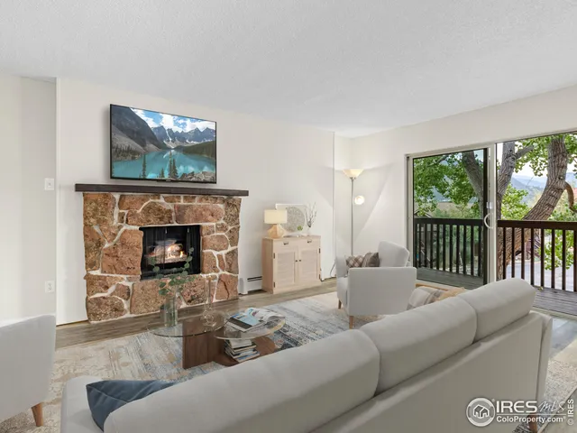 a view of empty room with wooden floor and fireplace